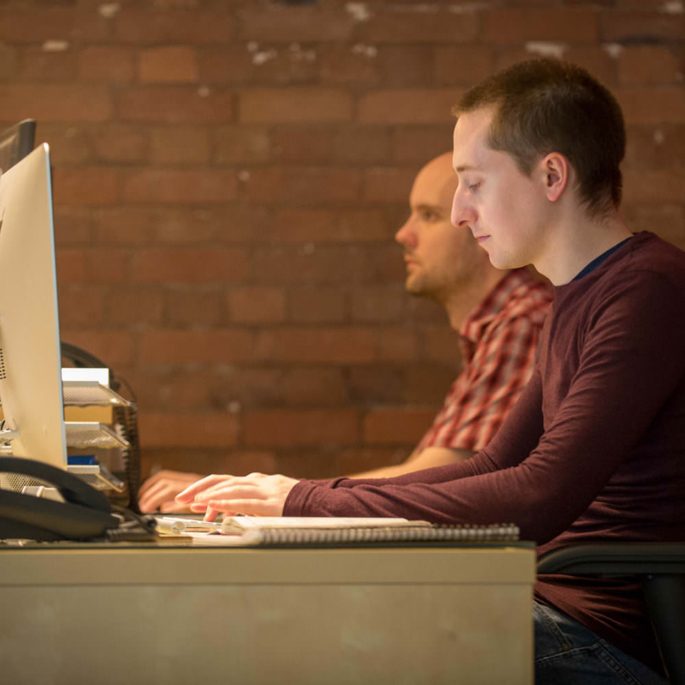 Two Web Developers Using Their Computers