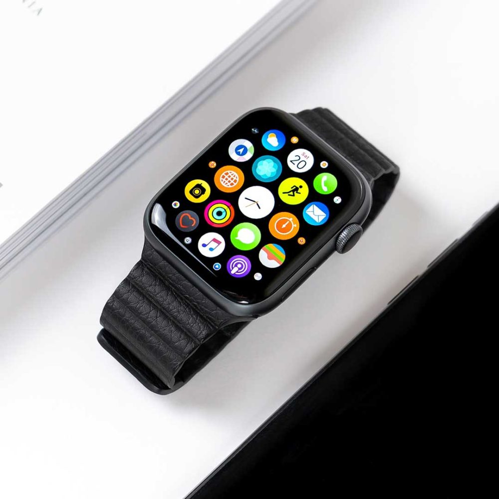 Apple Watch On Table Displaying Home Screen